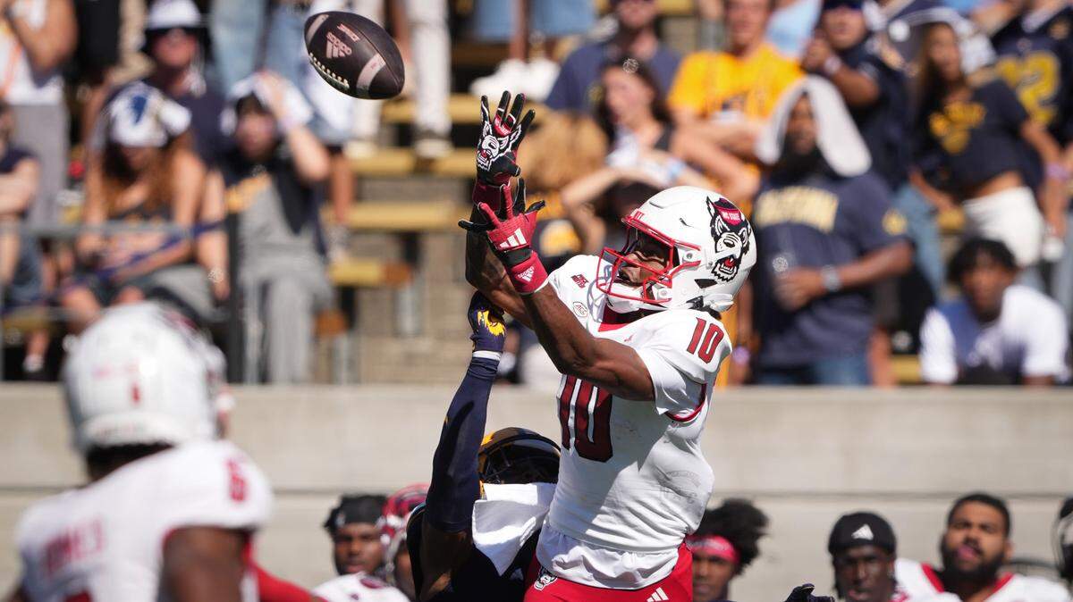 North Carolina State Wolfpack wide receiver Kevin Concepcion (10) catches a pass against California Golden Bears defensive back Craig Woodson (center left) during the second quarter at California Memorial Stadium.