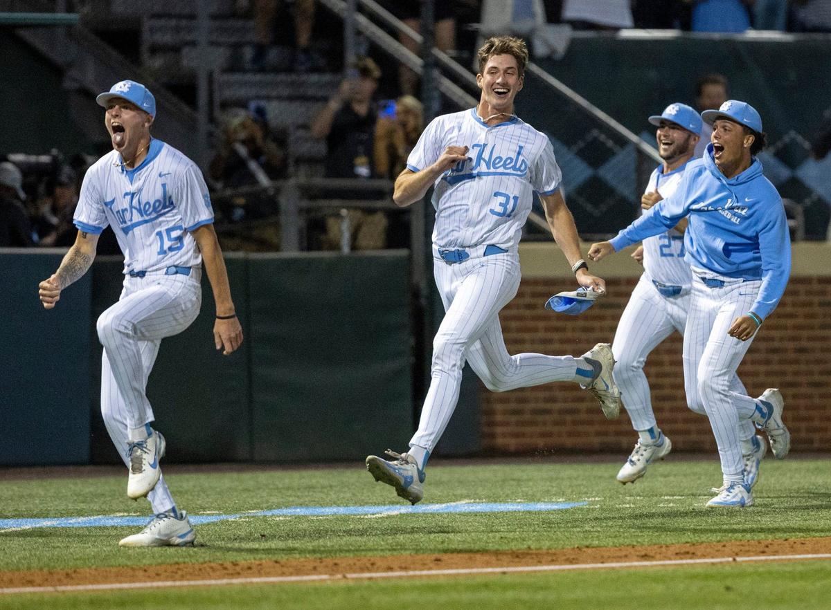 North Carolina pitchers Cameron Padgett (15) and Olin Johnson (31) storm out the the bullpen and head to home plate to celebrate their 11-8 victory over Long Island University following Gavin Gallaher’s walk-off grand slam in the bottom of the ninth inning during the NCAA Regional on Friday, May 31, 2024 at Boshamer Stadium in Chapel Hill, N.C.