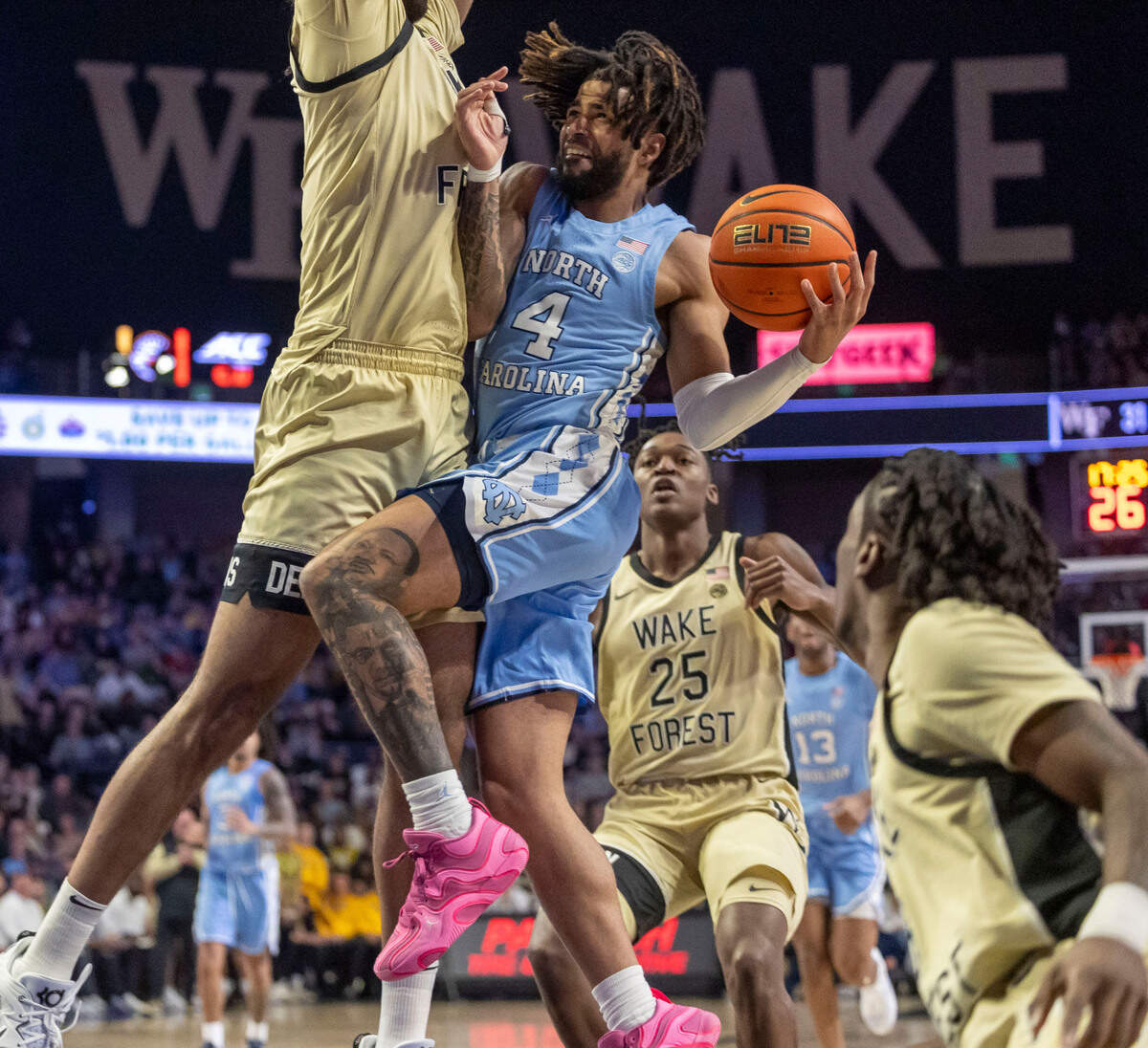 Wake Forest’s Efton Reid III (4) stops North Carolina guard R.J. Davis (4) as he drives in the lane in the second half on Tuesday, January 21, 2025 at Lawrence Joel Coliseum in Winston-Salem, N.C.
