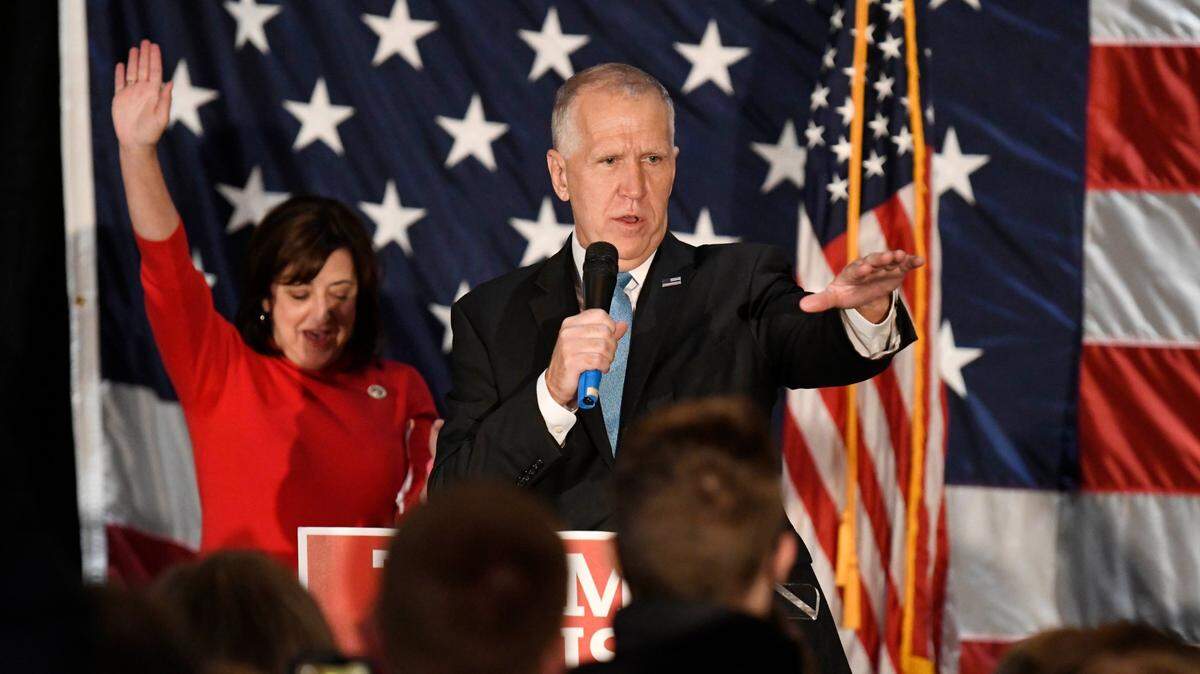 U.S. Sen. Thom Tillis of North Carolina addresses his supporters as wife Susan waves in the background after winning re-election during an election return party at Langtree Plantation in Mooresville, NC on Tuesday, November 3, 2020