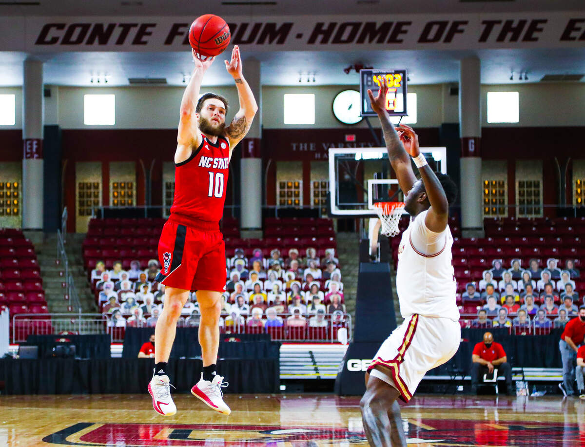 N.C. State guard Braxton Beverly shoots over a Boston College defender in first half action Saturday, Feb. 6, 2021.