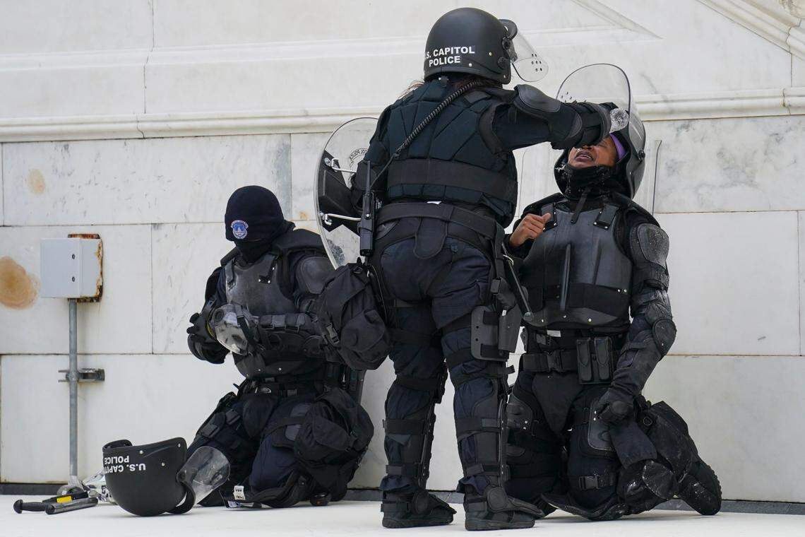 A police officer has eyes flushed with water after a confrontation with demonstrators, Wednesday, Jan. 6, 2021, at the Capitol in Washington. As Congress prepares to affirm President-elect Joe Biden’s victory, thousands of people have gathered to show their support for President Donald Trump and his claims of election fraud.