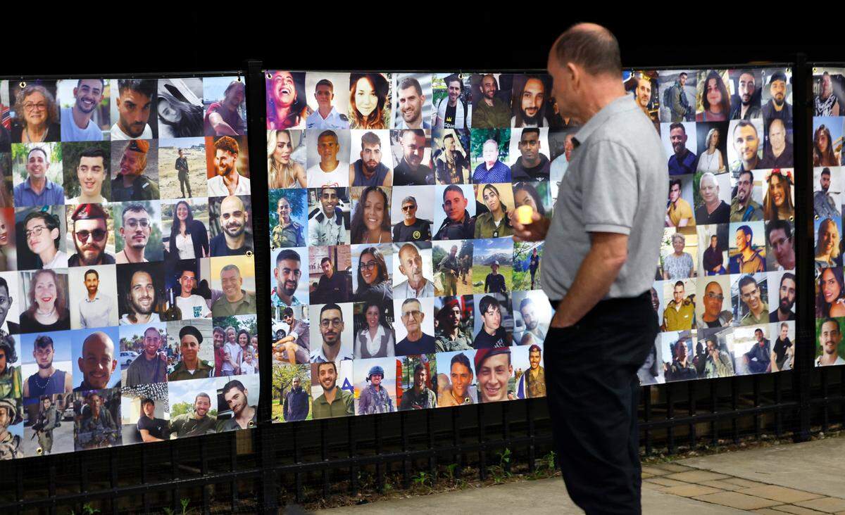 Attendees look at some of the faces of the over 1200 people killed in the October 7th attack on Israel by Hamas. The display of those killed was up as part of an October 7th Commemoration presented by the Jewish Federation of Greater Raleigh Monday, Oct. 7, 2024.