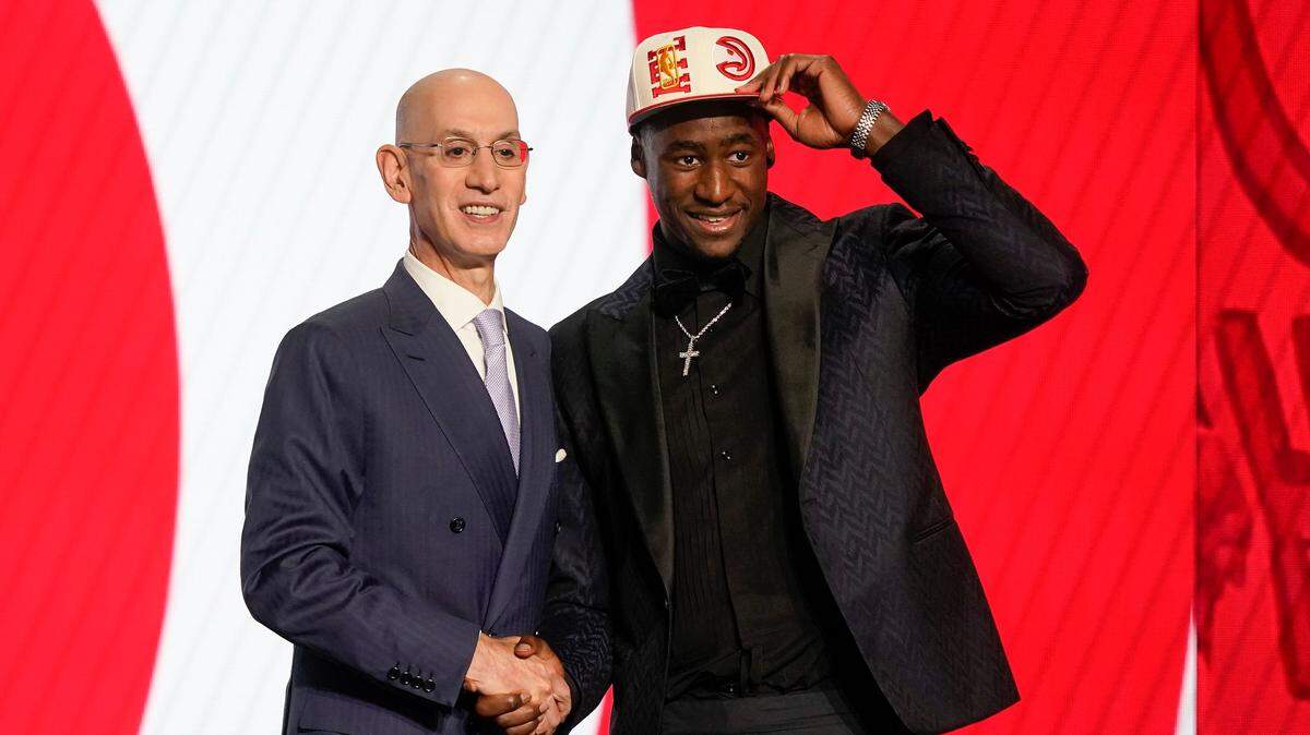 A.J. Griffin tips his cap alongside NBA Commissioner Adam Silver after being selected 16th overall by the Atlanta Hawks in the NBA basketball draft, Thursday, June 23, 2022, in New York. (AP Photo/John Minchillo)