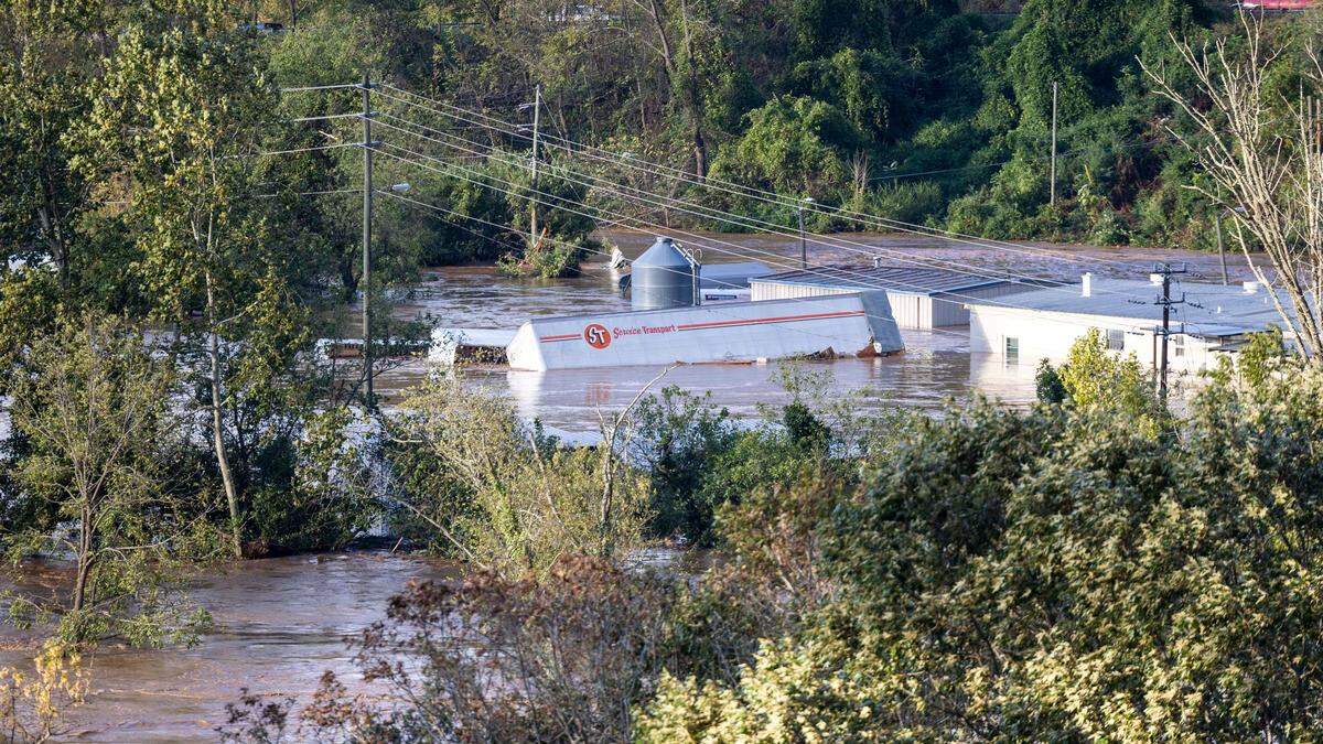 The French Broad River breaks its banks in Asheville on Friday, Sept. 27, 2024 as the remnants of Hurricane Helene caused flooding, downed trees, and power outages in western North Carolina.