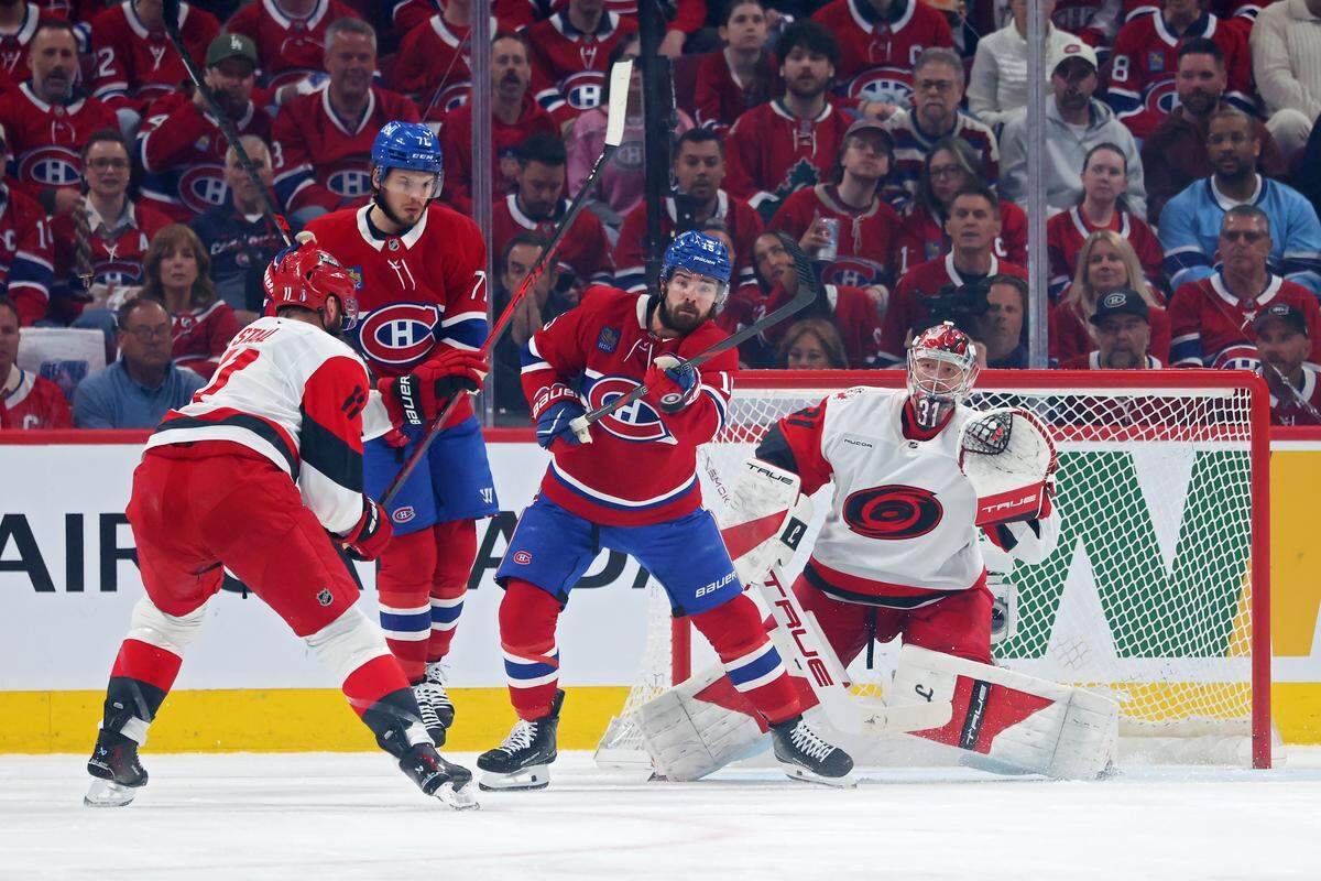 Carolina Hurricanes goalie Frederik Andersen tracks the puck as Montreal Canadiens forwards Alex Newhook and Jake Evans try to tip it in during the first period in Game 4 of the Eastern Conference Final of the 2026 Stanley Cup Playoffs at Bell Centre on May 27, 2026 in Montreal, Quebec, Canada.