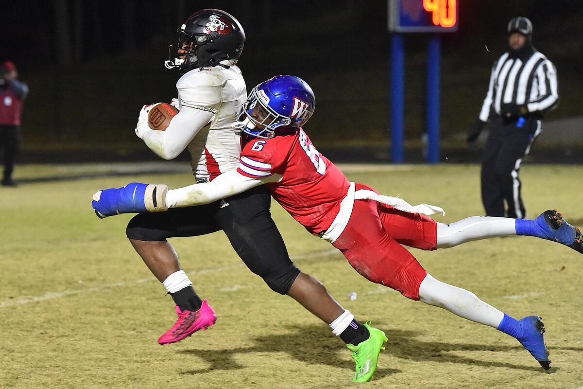Rolesville’s Isiah Jones (2) runs for the touchdown against Wake Forest’s Zion Frink (6) during the second half. The Rolesville Rams and the Wake Forest Cougars met in the NCHSAA 4A third round playoff game in Wake Forest, NC on November 18, 2022