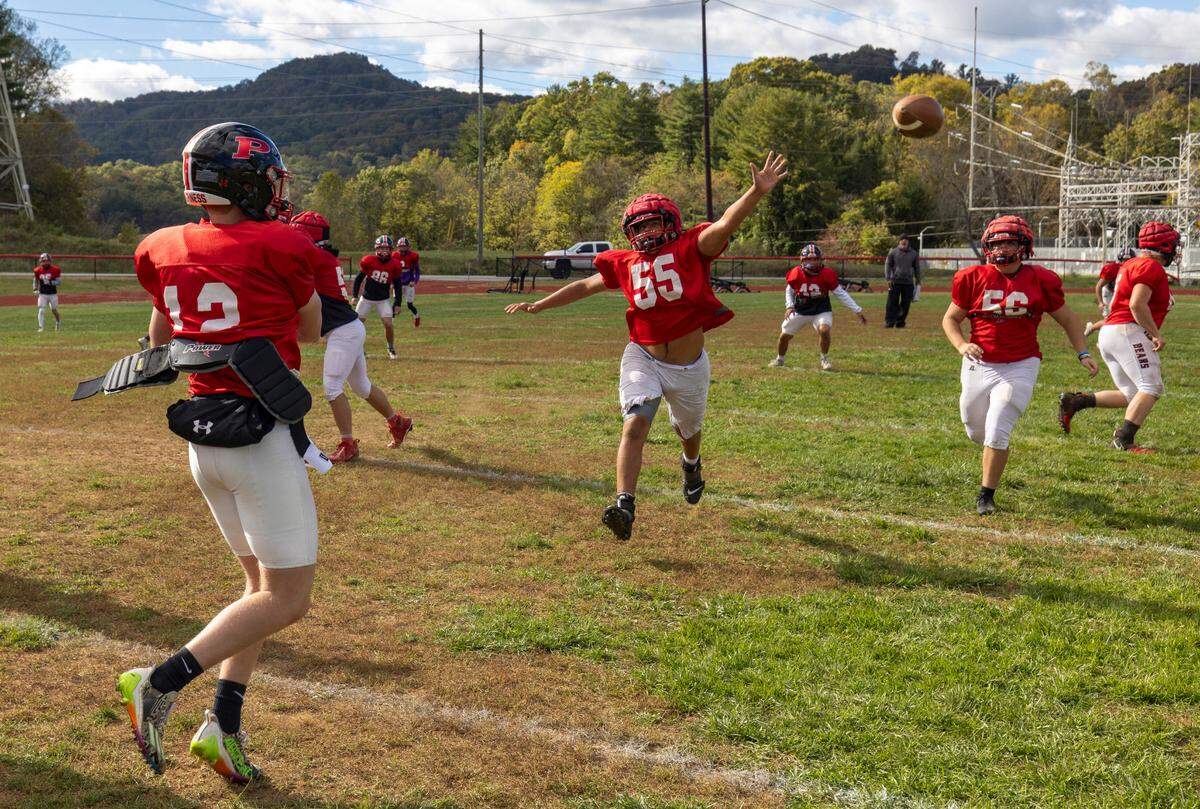 The Pisgah High School football team runs an offensive set during practice on Wednesday, October 16, 2024 in Canton, N.C. Two of the team’s players lost their homes during Hurricane Helene. The team lost its home field, Pisgah Memorial Stadium from Pigeon River flooding.