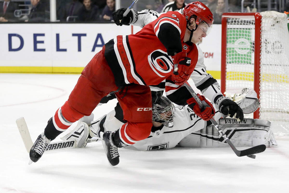 Los Angeles Kings goaltender Jonathan Quick blocks a shot by Carolina Hurricanes left wing Brock McGinn during the third period of an NHL hockey game in Los Angeles, Sunday, Dec. 2, 2018. The Kings won 2-0.