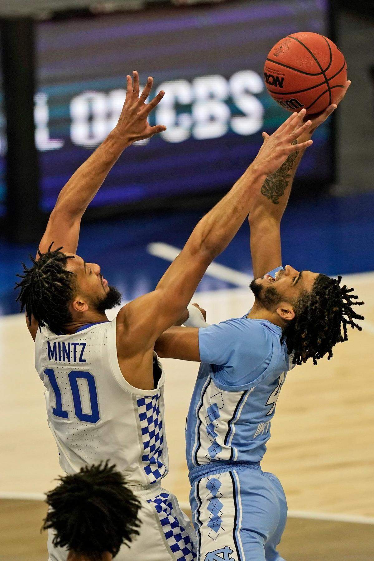 North Carolina’s R.J. Davis (4) drives to the basket against Kentucky’s Davion Mintz (10) in the first half of an NCAA college basketball game, Saturday, Dec. 19, 2020, in Cleveland.