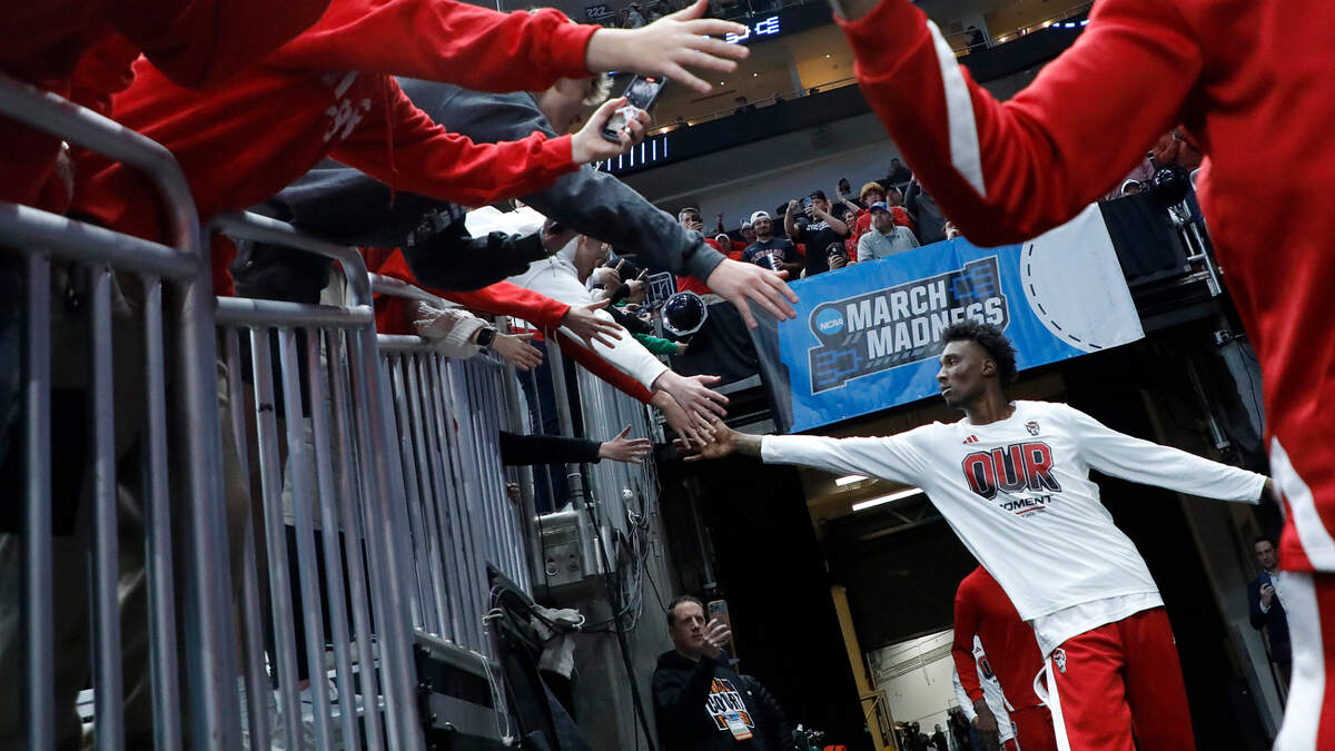 N.C. State’s Ernest Ross high-fives fans as the Wolfpack take the court prior to their NCAA Tournament second round game against Oakland on Saturday, March 23, 2024, at PPG Paints Arena in Pittsburgh, Pa.