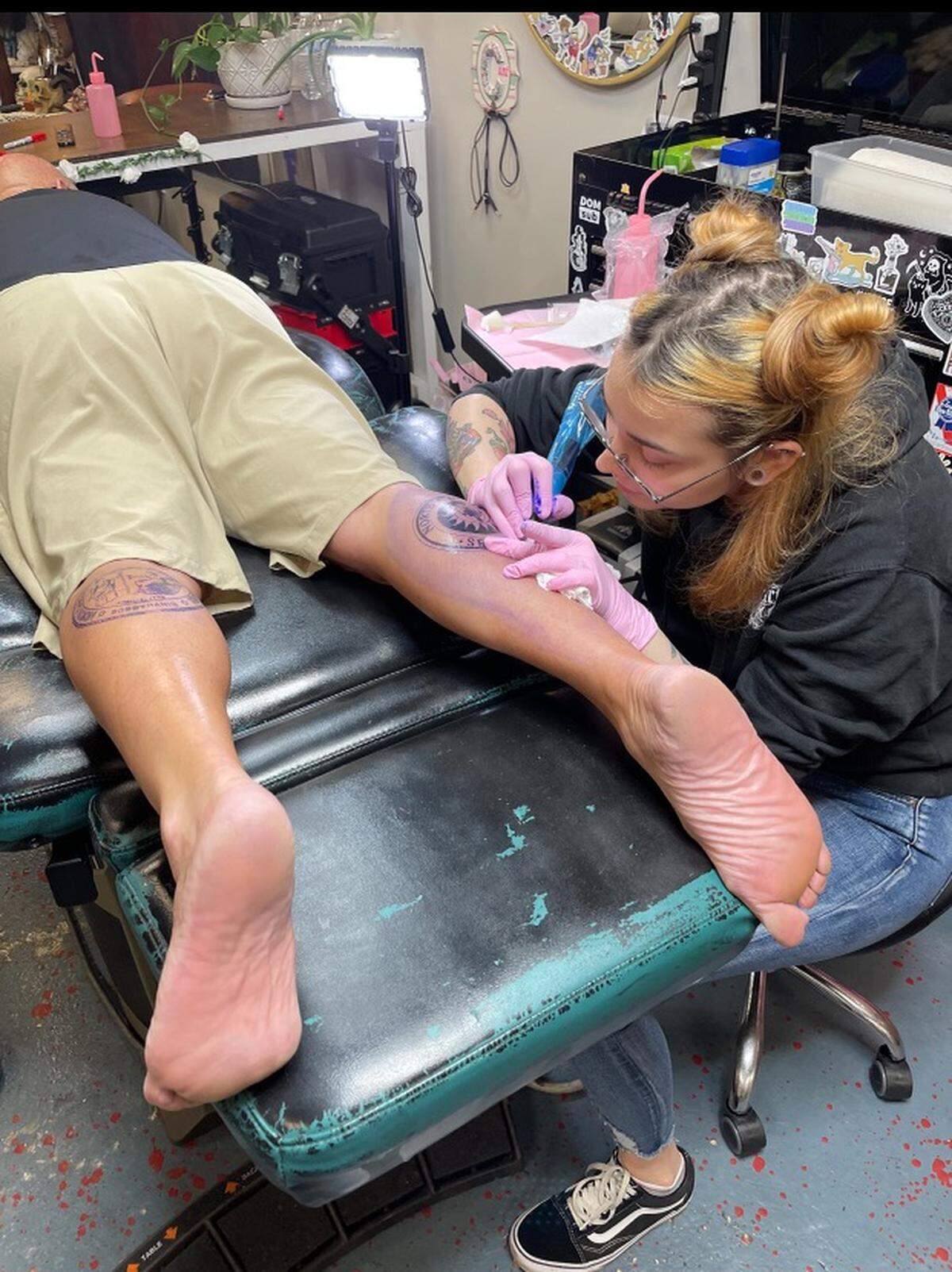 A Elizabeth City tattoo artist adds the North Carolina Senate seal to state Sen. Bobby Hanig’s leg Friday, July 14, 2023.