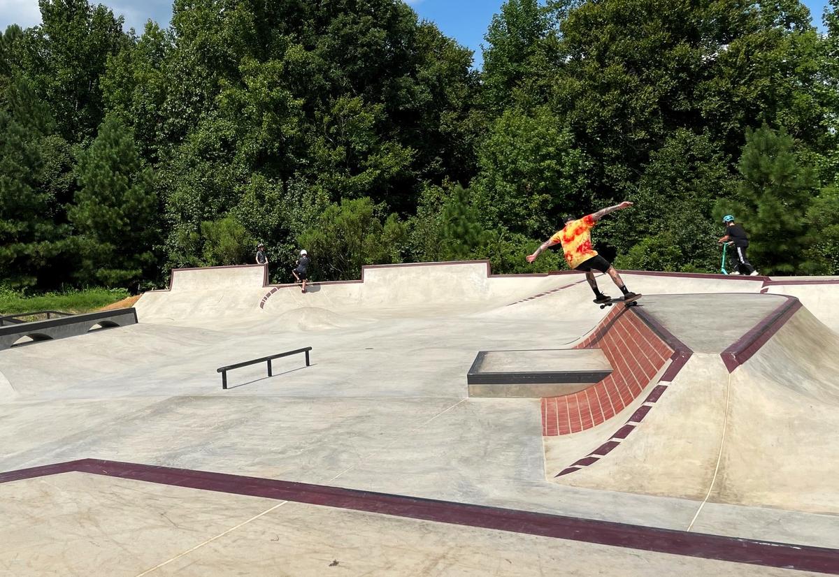 A skateboarder leans into the fall from a brick ramp on Monday, Aug. 12, 2024, at Hillsborough’s Skate Spot, located in Cates Creek Park off Old N.C. 86 in Hillsborough, N.C.