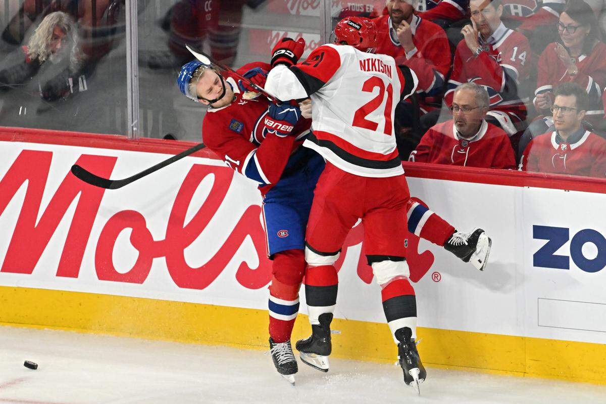 Alexander Nikishin #21 of the Carolina Hurricanes checks Kaiden Guhle #21 of the Montreal Canadiens during the second period in Game Four of the Eastern Conference Final of the 2026 Stanley Cup Playoffs at Bell Centre on May 27, 2026 in Montreal, Quebec, Canada.