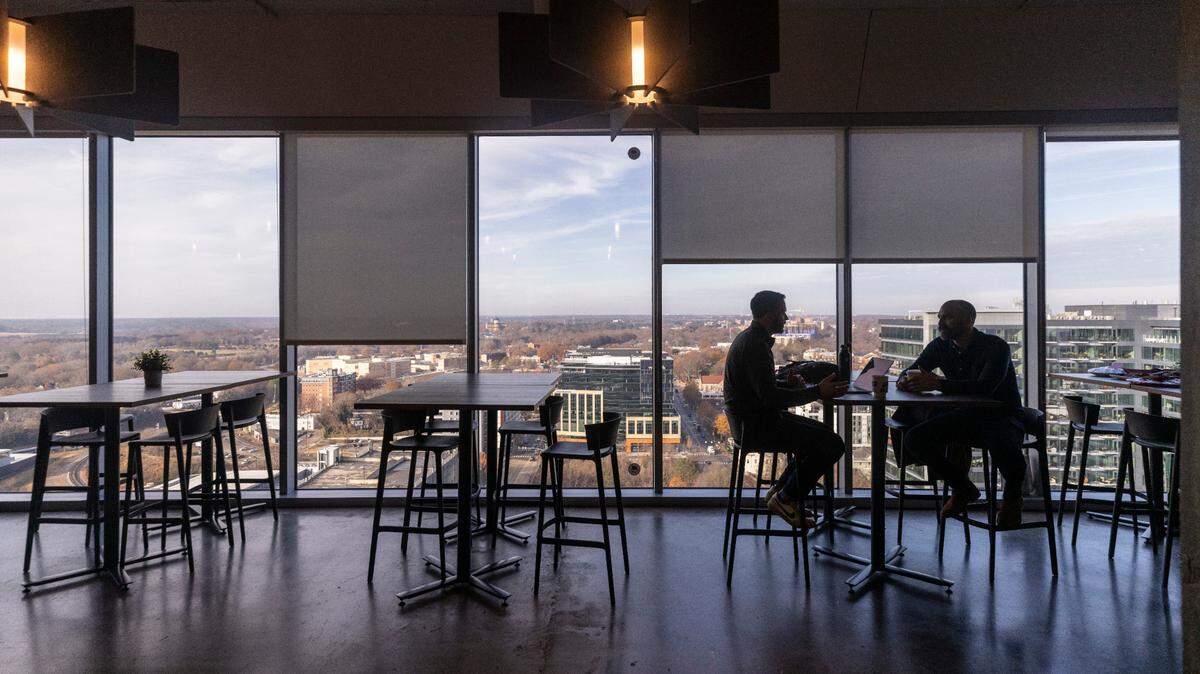 Pendo employees talk in a break area inside the Pendo building in downtown Raleigh.







