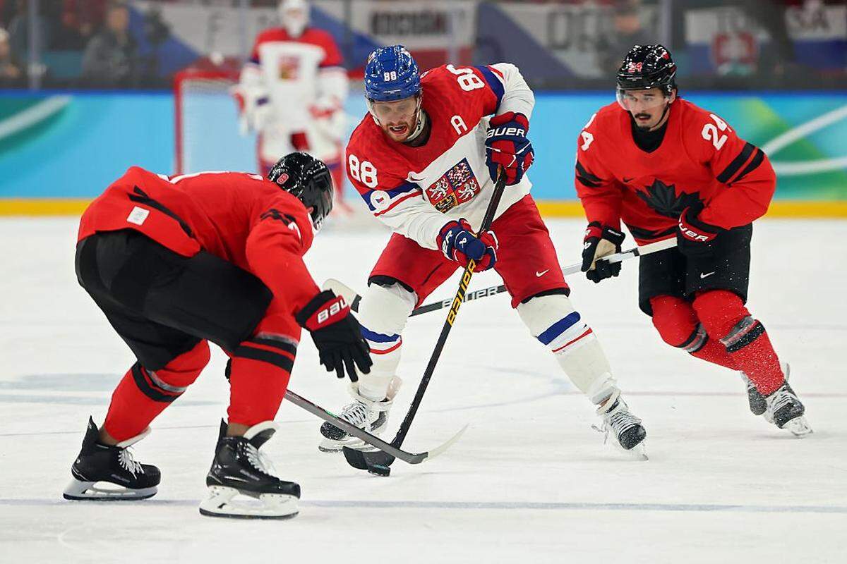 David Pastrnak (88) of Team Czechia controls the puck against Cale Makar (8) and Seth Jarvis of Team Canada during the men's quarterfinal between Canada and Czechia on Day 12 of the Milano Cortina 2026 Winter Olympic games at Milano Santagiulia Ice Hockey Arena on Feb. 18, 2026 in Milan, Italy.
