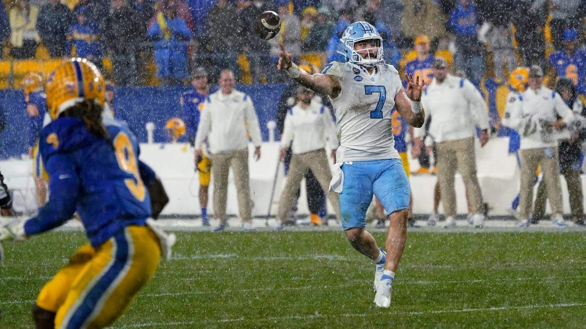 North Carolina quarterback Sam Howell (7) throws a pass as Pittsburgh defensive back Brandon Hill (9) defends during overtime in an NCAA college football game Thursday, Nov. 11, 2021, in Pittsburgh. Pittsburgh won 30-23 in overtime. (AP Photo/Keith Srakocic)
