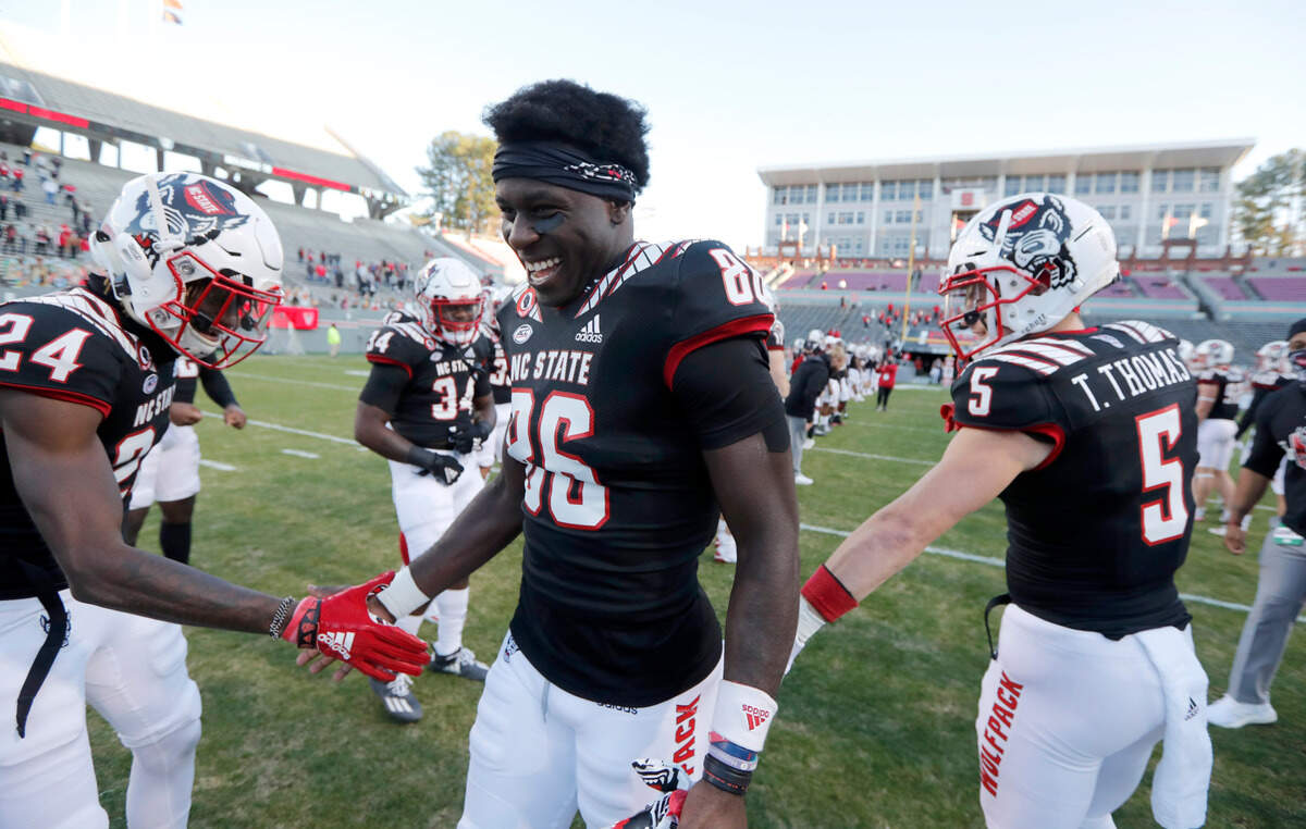 N.C. State wide receiver Emeka Emezie (86) greets teammates after being acknowledged during senior day before N.C. State’s game against Georgia Tech at Carter-Finley Stadium in Raleigh, N.C., Saturday, Dec. 5, 2020.