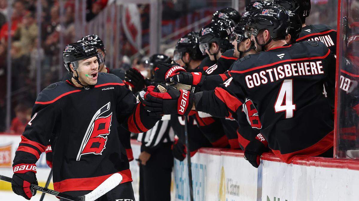 Logan Stankoven (22) of the Carolina Hurricanes celebrates with his team following a goal during the first period against the Dallas Stars at Lenovo Center on Jan. 6, 2026 in Raleigh, North Carolina.
