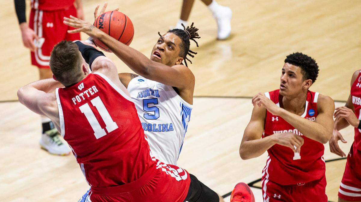 North Carolina’s Armando Bacot (5) has a shot knocked away by Wisconsin’s Micah Potter (11) during the second half of a first-round game in the NCAA men’s college basketball tournament, Friday, March 19, 2021, at Mackey Arena in West Lafayette, Ind. 