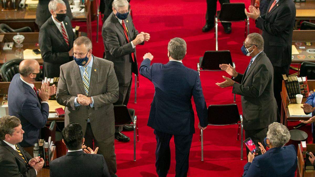 North Carolina Gov. Roy Cooper is greeted by lawmakers as he enters the House chamber to deliver his State of the State address before a joint session of the North Carolina House and Senate on Monday, April 26, 2021 in Raleigh, N.C.