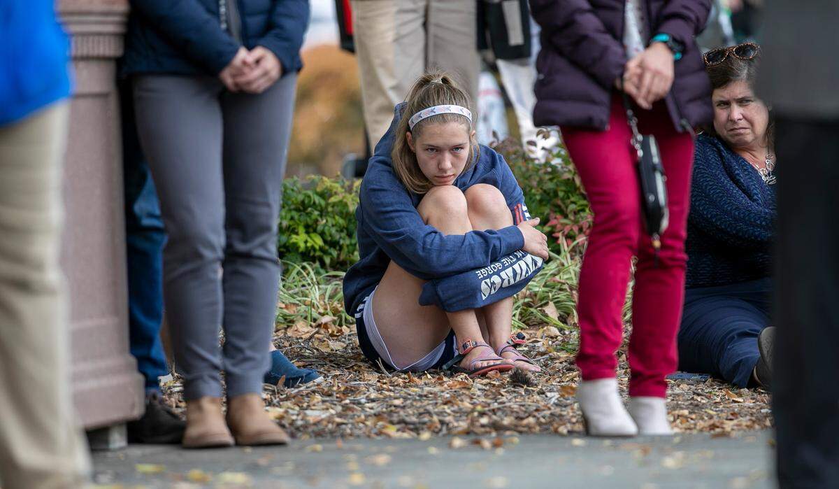 Abby Moe, center, listens as Raleigh Mayor Mary-Ann Baldwin honors the victims of the mass shooting that killed five people on October 13, 2022 in the Hedingham neighborhood, during a vigil on Sunday, October 23, 2022 on Lichtin Plaza at Raleigh Memorial Auditorium in Raleigh, N.C.