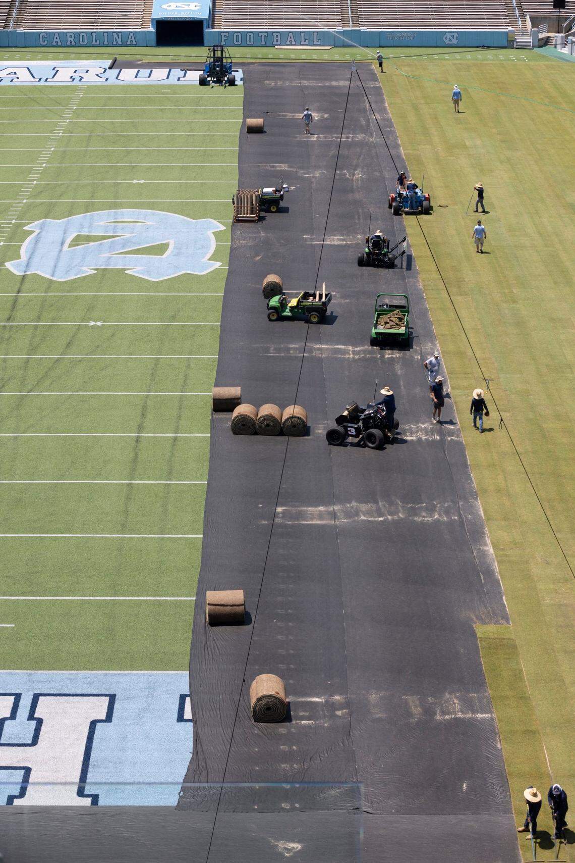 Crews from Carolina Green and the University of North Carolina Turf Management install nearly 100,000 square feet of fresh sod atop the artificial turf in Kenan Stadium in preparation for the FC Series game between Chelsea and Wrexham on Wednesday, July 12, 2023 in Chapel Hill, N.C. The Bermuda 419 sod was grown in Indian Trail, N.C., is 1.5 inches thick, and was installed upon a layer of geo-textile base over the artificial turf. It will be removed following the soccer match on July 19, 2023.