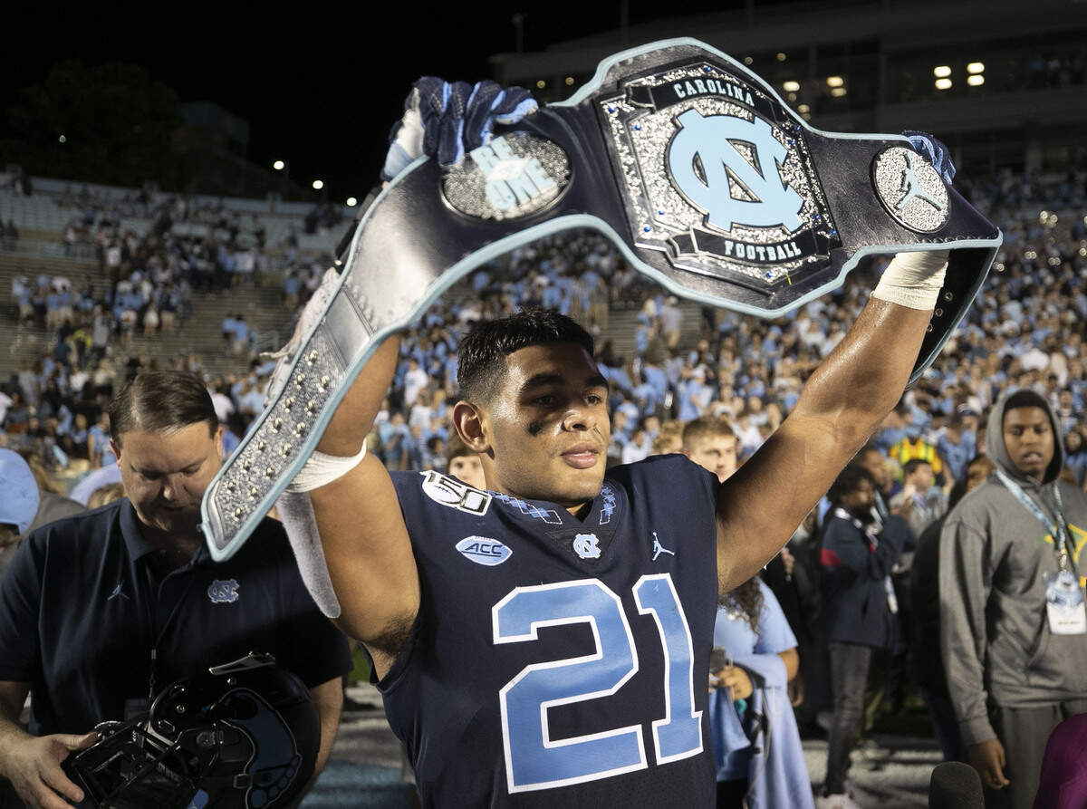 North Carolina linebacker Chazz Surratt (21) celebrates with the turnover belt after he intercepted a Deon Jackson pass with :14 seconds to play to secure the Tar Heels’ 20-17 victory over Duke on Saturday, October 26, 2019 at Kenan Stadium in Chapel Hill, N.C.