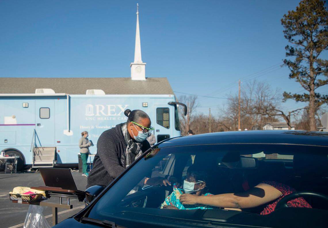 Registered nurse Kammira Holley administers a dose of the Moderna COVID-19 vaccine to Lucille McNeill at UNC Health’s first mobile vaccine clinic outside HowellÕs Chapel Church of Christ, on Wednesday, Feb. 3, 2021, Selma, N.C.