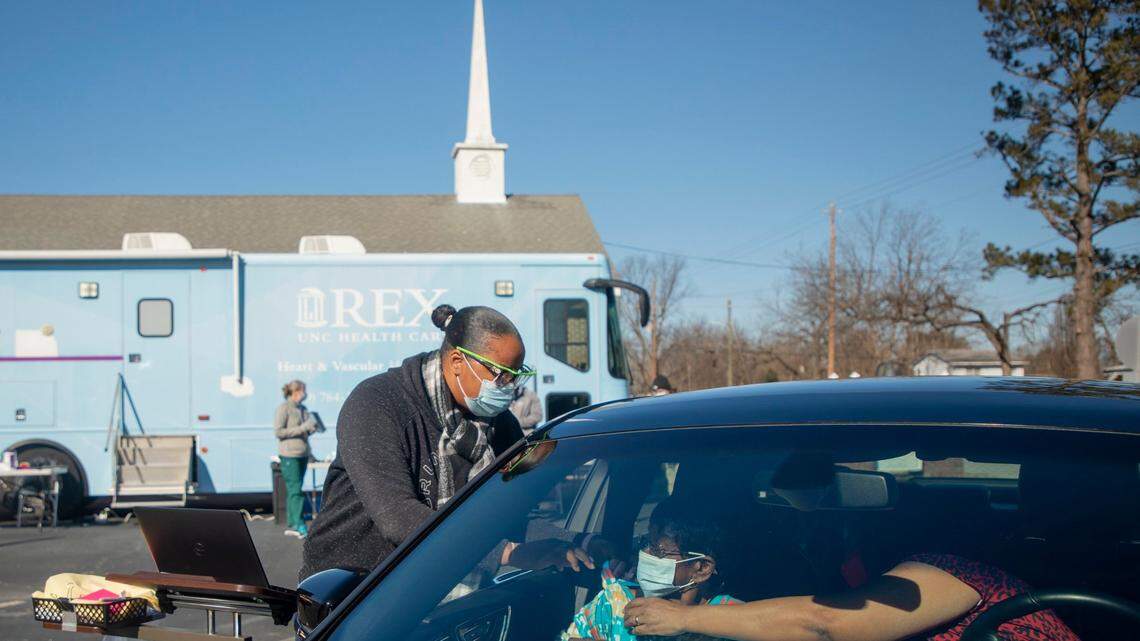 Registered nurse Kammira Holley administers a dose of the Moderna COVID-19 vaccine to Lucille McNeill at UNC Health’s first mobile vaccine clinic outside HowellÕs Chapel Church of Christ, on Wednesday, Feb. 3, 2021, Selma, N.C.