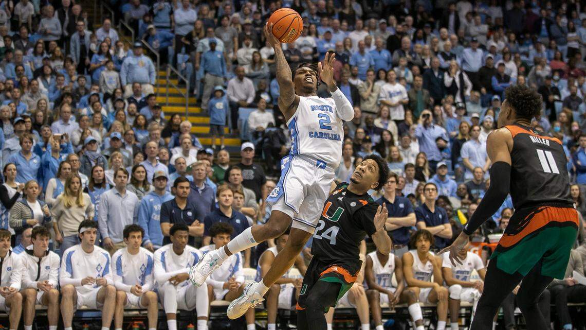 North Carolina’s Caleb Love (2) drives to the basket against Miami’s Nijel Pack (24) in the second half on Monday, February 13, 2023 at the Smith Center in Chapel Hill, N.C.