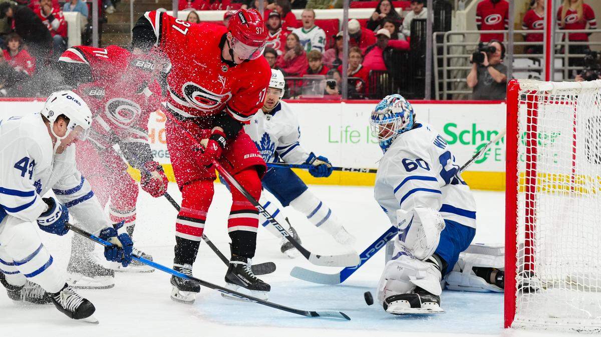 Toronto Maple Leafs goaltender Joseph Woll (60) stops the scoring attempt by Carolina Hurricanes right wing Andrei Svechnikov (37) during the first period at Lenovo Center.