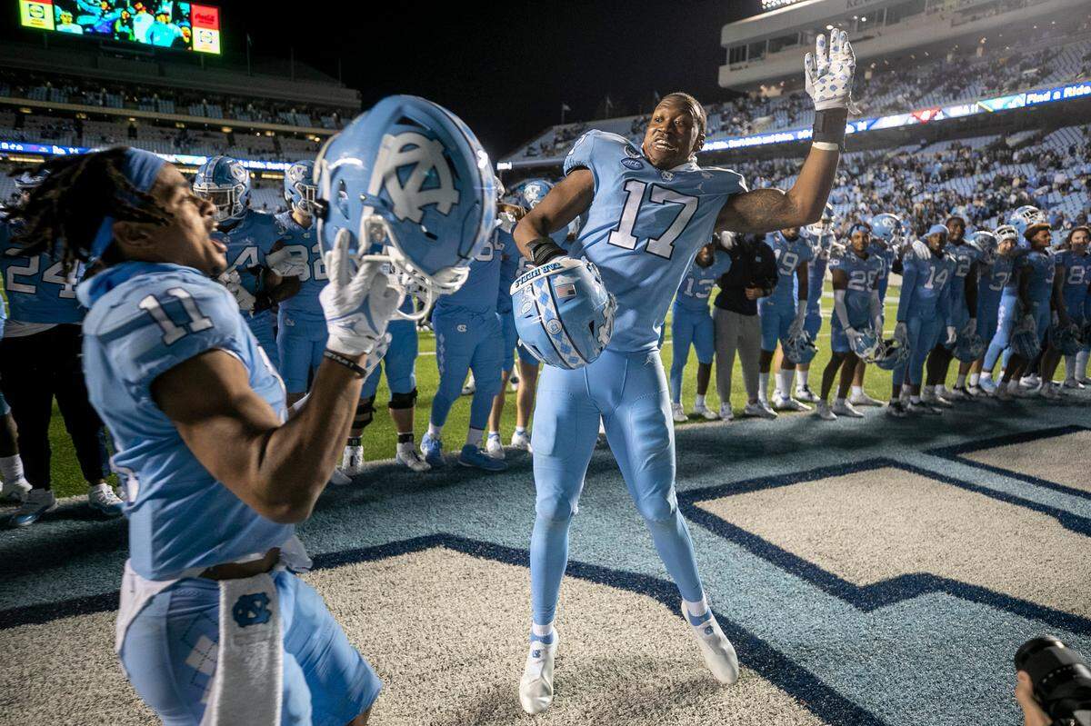 North Carolina’s Chris Collins (17) celebrates with Josh Downs (11) and his teammates following the Tar Heels’ 42-24 victory over Pitt on Saturday, October 29, 2022 at Kenan Stadium in Chapel Hill, N.C.