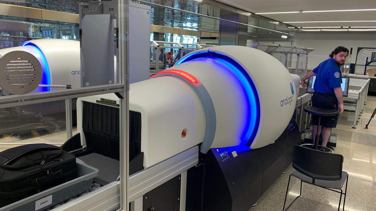 Transportation Security Administration officer Connor McKeown demonstrates the new computed tomography or CT scanners that the TSA now uses to screen carry-on bags at Raleigh-Durham International Airport.