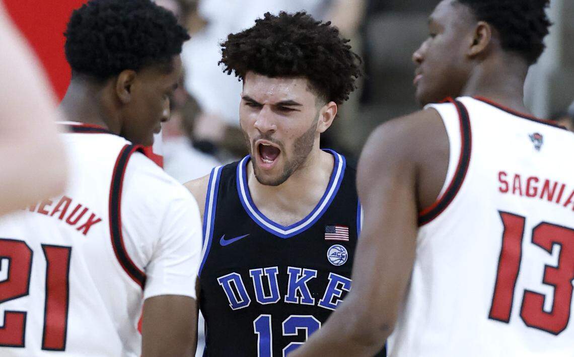 Duke’s Cameron Boozer (12) celebrates after making the basket while being fouled during the first half of Duke’s game against N.C. State at the Lenovo Center in Raleigh, N.C., Monday, March 2, 2026. NC State's Terrance Arceneaux (21) stands to the left and Musa Sagnia (13) is to the right.