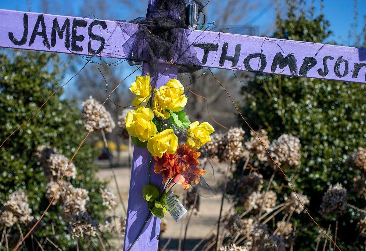A cross memorializes James Thompson, a victim of the mass shooting, at the entrance to the Hedingham neighborhood on Friday, January 13, 2023 in Raleigh, N.C.