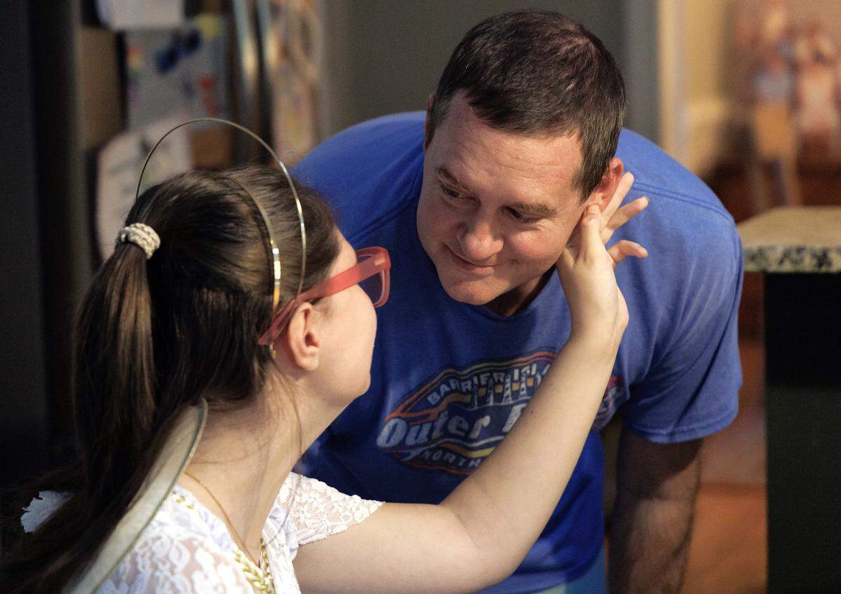 Lexi Abernethy greets David Caraway prior to attending a Halloween party. 