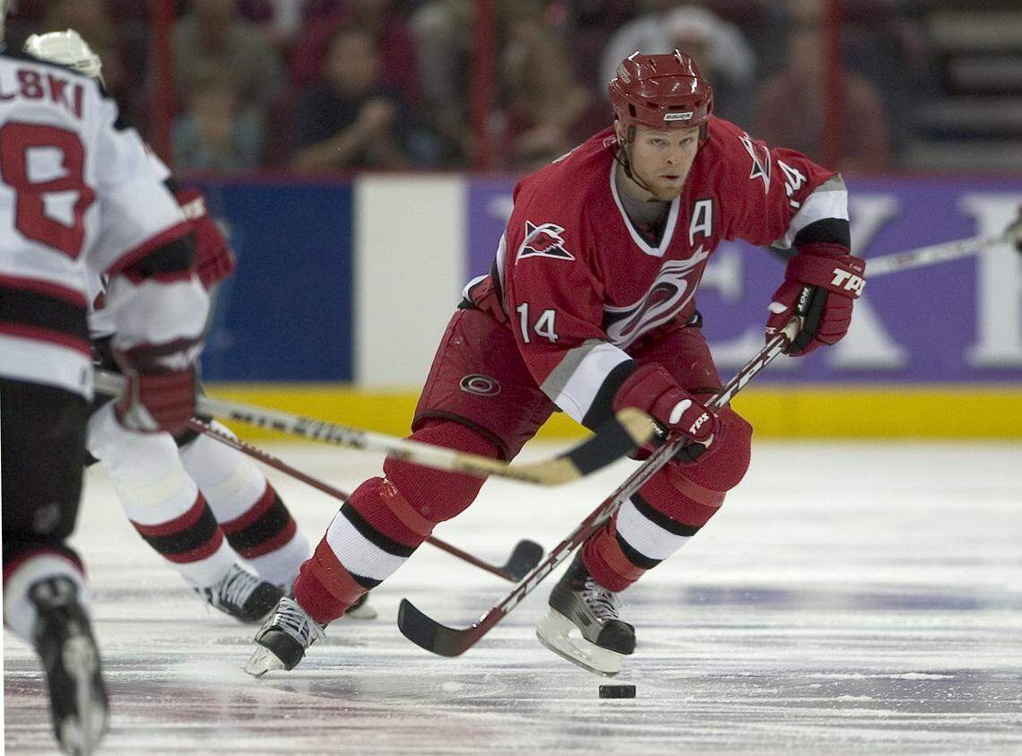 Kevyn Adams controls the puck as he skates past New Jersey Devils Brian Rafalski (28) at mid-ice during the third period of play on May 14, 2006 at the RBC Center.