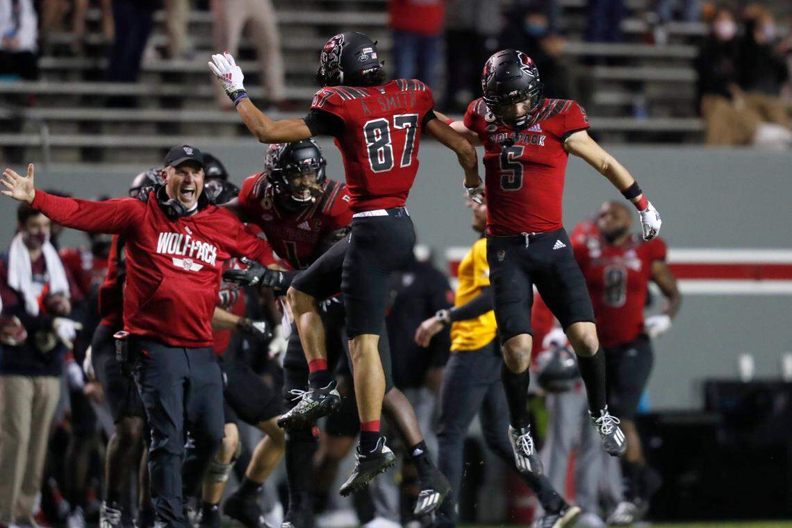 N.C. State’s Anthony Smith (87) celebrates with Thayer Thomas (5) after Smith recovered a fumble during the second half of N.C. State’s 38-22 victory over Florida State at Carter-Finley Stadium in Raleigh, N.C., Saturday, Nov. 14, 2020.