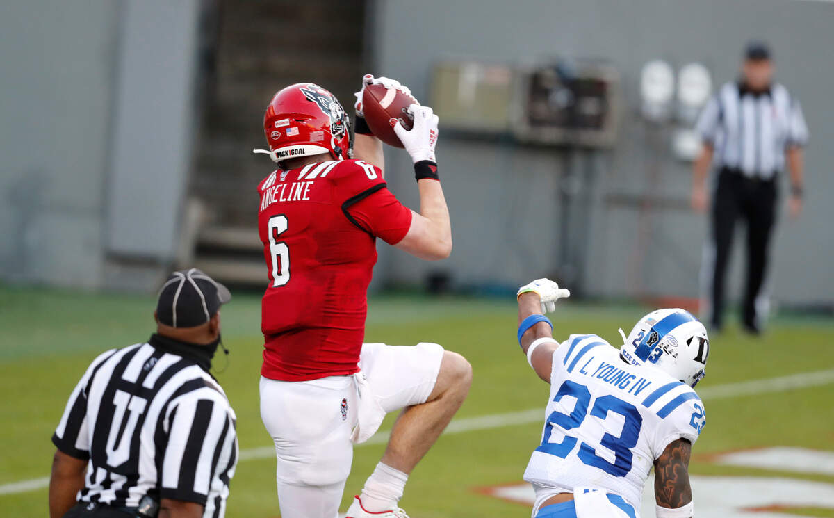 N.C. State tight end Cary Angeline (6) pulls in a 4-yard touchdown reception as Duke safety Lummie Young IV (23) defends during the second half of N.C. State’s 31-20 victory over Duke at Carter-Finley Stadium in Raleigh, N.C., Saturday, Oct. 17, 2020.