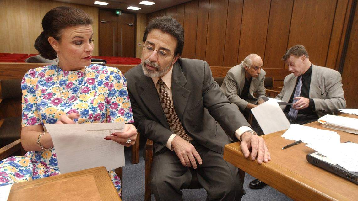 In this 2003 file photo, Durham assistant District Attorney Freda Black looks over paperwork with defense attorney David Rudolf as the Michael Peterson murder trial finished it’s sixth week of jury selection.