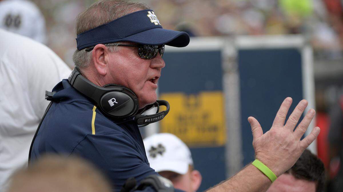 Notre Dame head coach Brian Kelly talks to players at the bench during the 2019 Camping World Bowl Fla.The 10th-ranked Fighting Irish, taking a one-year sabbatical from football independence to join the Atlantic Coast Conference race, opened against league rival Duke Sept. 12 at Notre Dame Stadium. (AP Photo/Phelan M. Ebenhack, File)