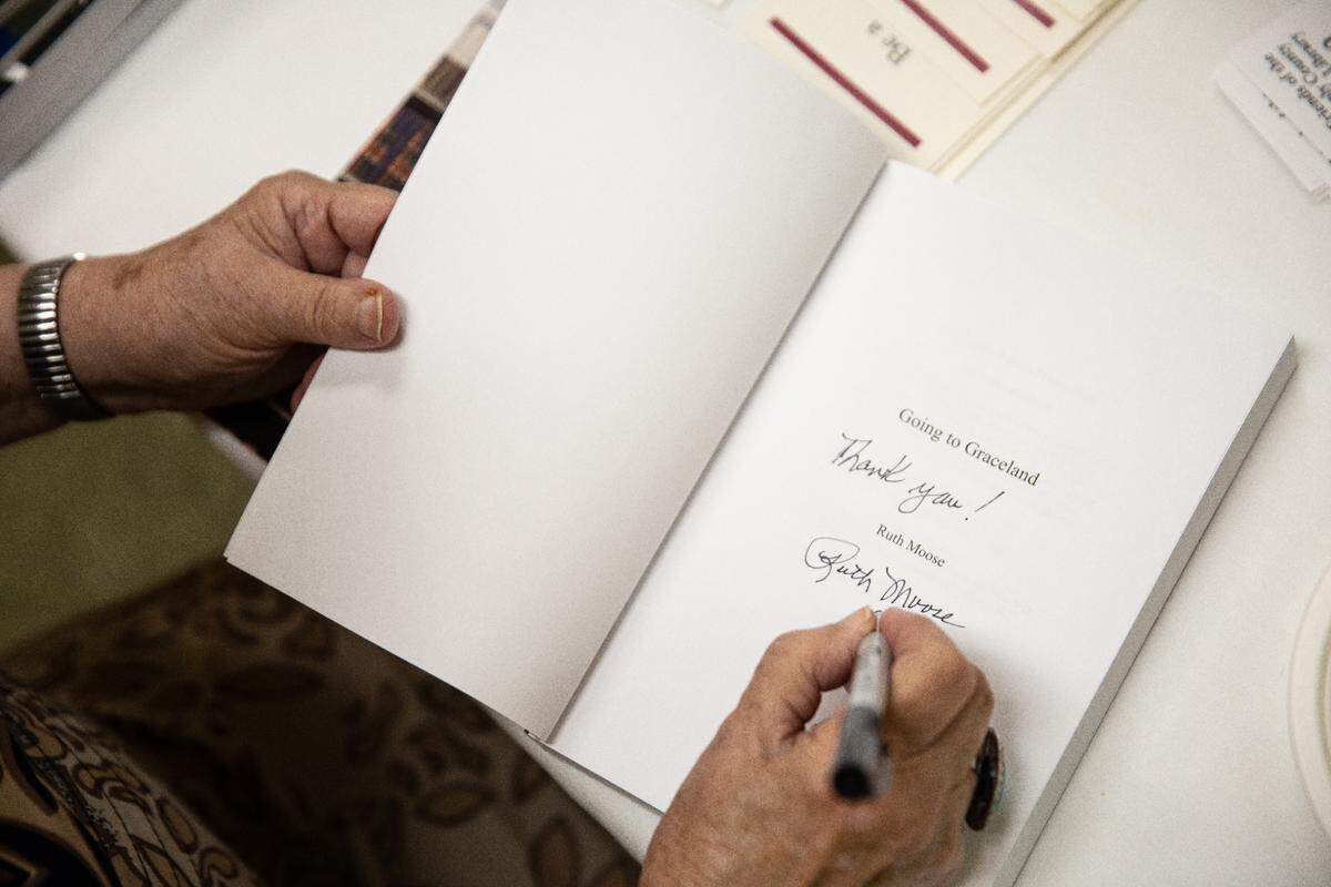 Ruth Moose signs a book for a buyer after her speaking engagement at the Stanly County Public Library on September 10, 2022.