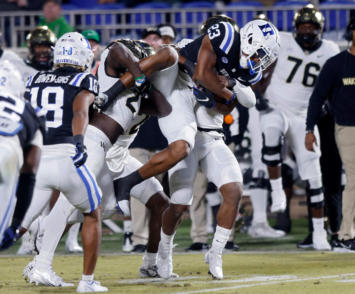 Duke’s Terry Moore is tackled by Wake Forest’s Jarrett Alston Jr. and Jacobi Gilbert during the second half of Duke’s final regular season game at Wallace Wade Stadium on Saturday, Nov. 26, 2022, in Durham, N.C.