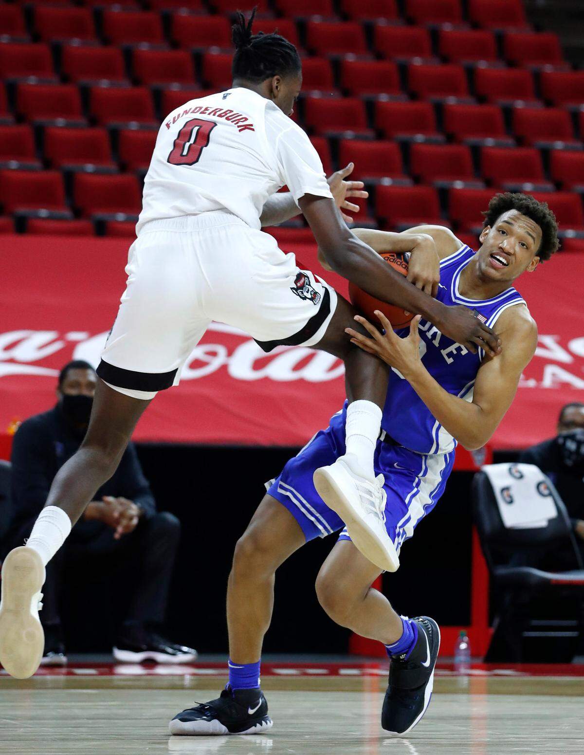 Duke’s Wendell Moore Jr. (0) keeps the ball from N.C. State’s D.J. Funderburk (0) during the second half of Duke’s 69-53 victory over N.C. State at PNC Arena in Raleigh, N.C., Saturday, February 13, 2021.