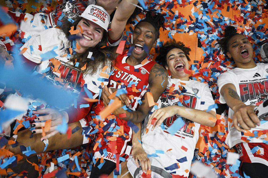 Mar 31, 2024; Portland, OR, USA; From left, NC State Wolfpack center River Baldwin (1), guard Saniya Rivers (22), guard Madison Hayes (21) and guard Aziaha James (10) celebrate after a game against the Texas Longhorns in the finals of the Portland Regional of the NCAA Tournament at the Moda Center center. Mandatory Credit: Troy Wayrynen-USA TODAY Sports