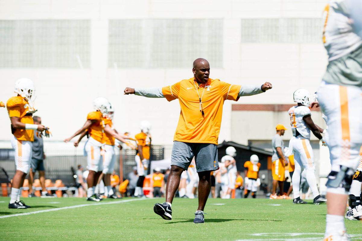 Tennessee Volunteers defensive backs coach Charlton Warren warms up with players during fall football practice at Anderson Training Facility.