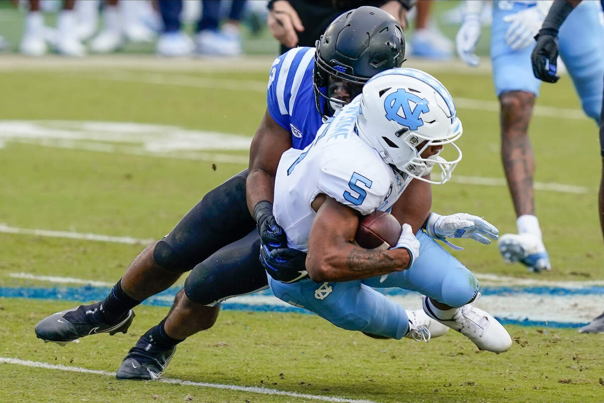 North Carolina Tar Heels wide receiver Dazz Newsome (5) is tackled by Duke Blue Devils cornerback Tony Davis (13) during the second half at Wallace Wade Stadium. 