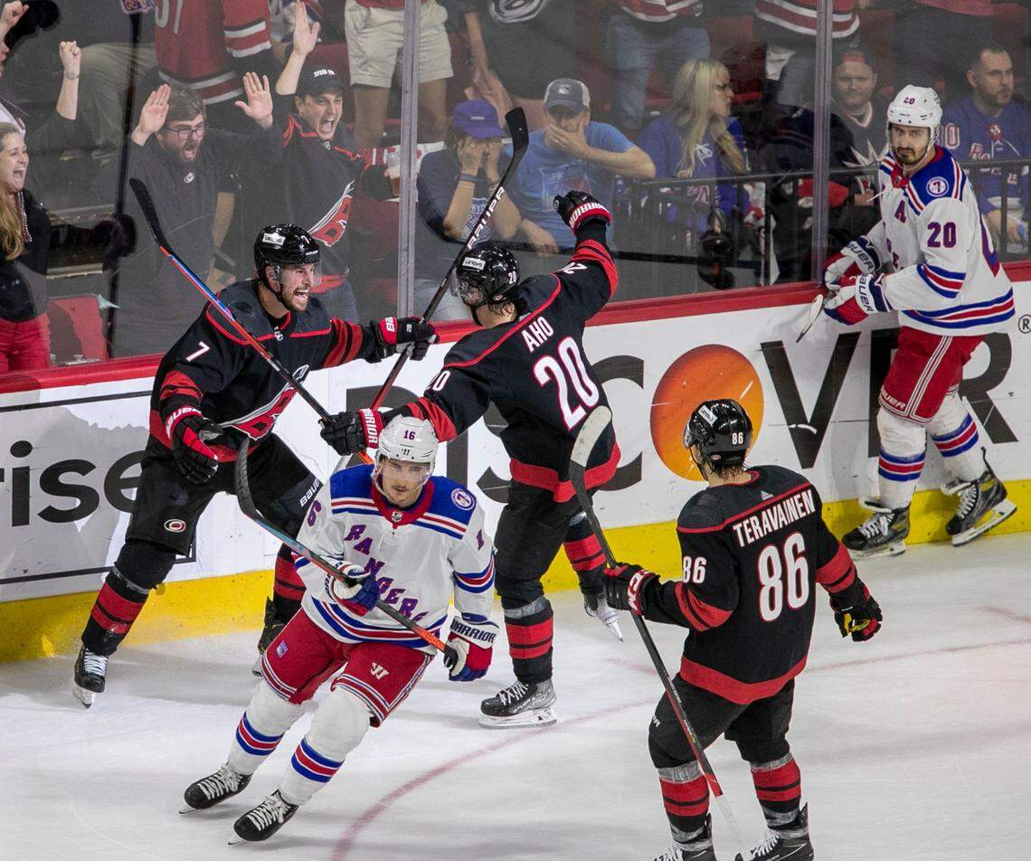 Carolina Hurricanes Brendan Smith (7) and Sebastian Aho (20) react after Smiths goal on New York Rangers goalie Igor Shesterkin (31) to give the Hurricanes a 1-0 lead in the second period on Friday, May 20, 2022 during game two of the Stanley Cup second round at PNC Arena in Raleigh, N.C.