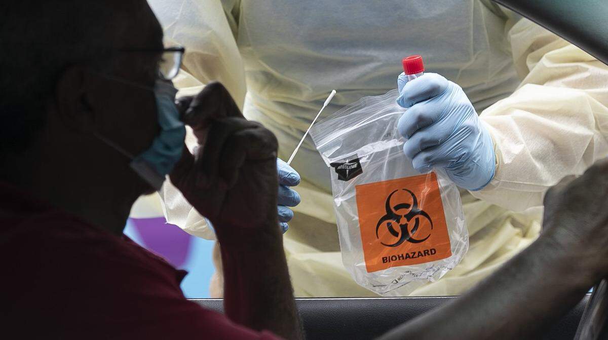 A technician from UNC Health conducts COVID-19 testing at Robert’s Park on Martin Street on Monday, September 8, 2020 in Raleigh, N.C.